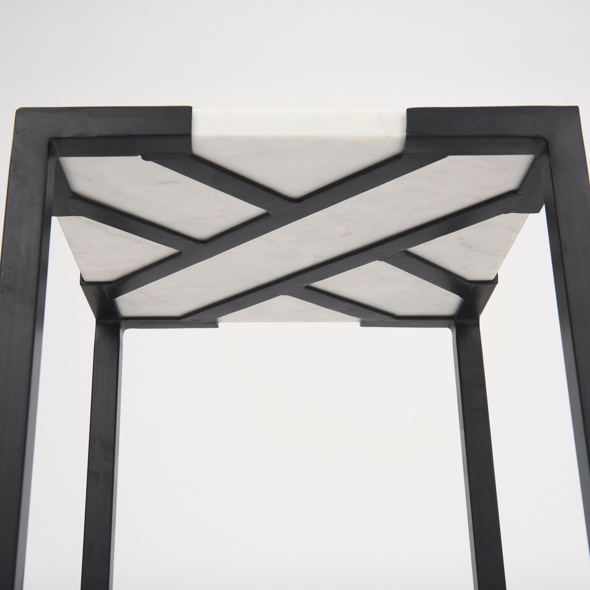 This set of nesting tables feature square, marble tops that rest neatly upon crisscross, iron frames.