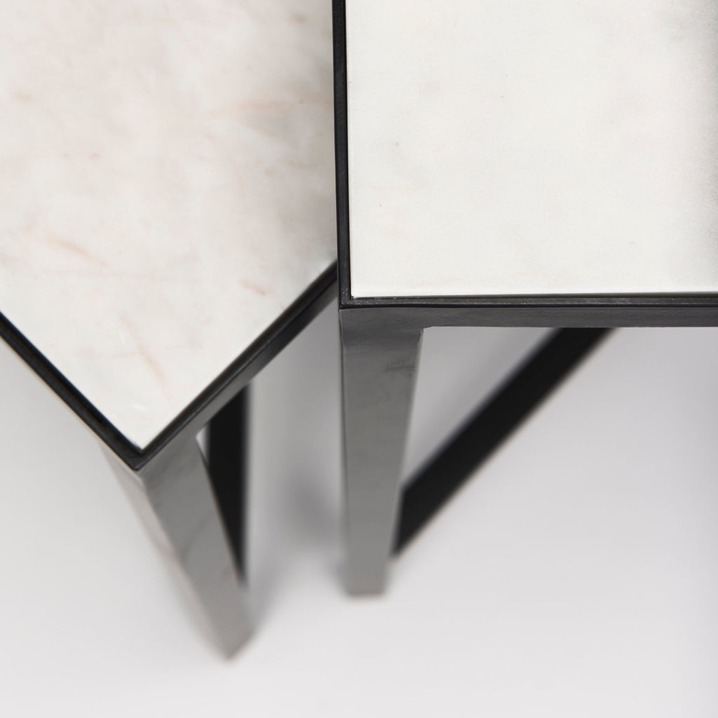 This set of nesting tables feature square, marble tops that rest neatly upon crisscross, iron frames.