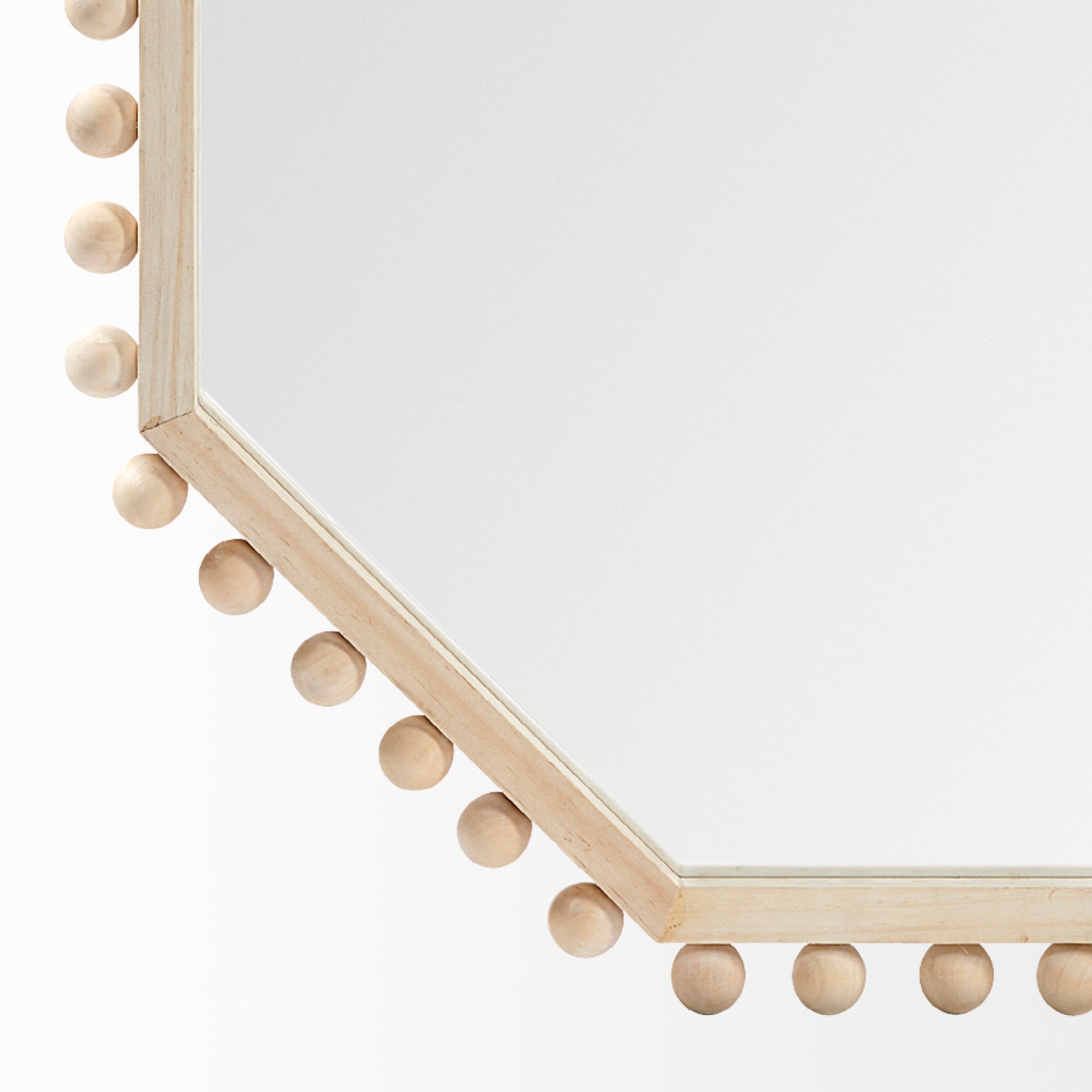 A WOOD FRAMED MIRROR WITH AN octogonal SHAPE AND BEADED DETAIL AROUND THE EDGE.