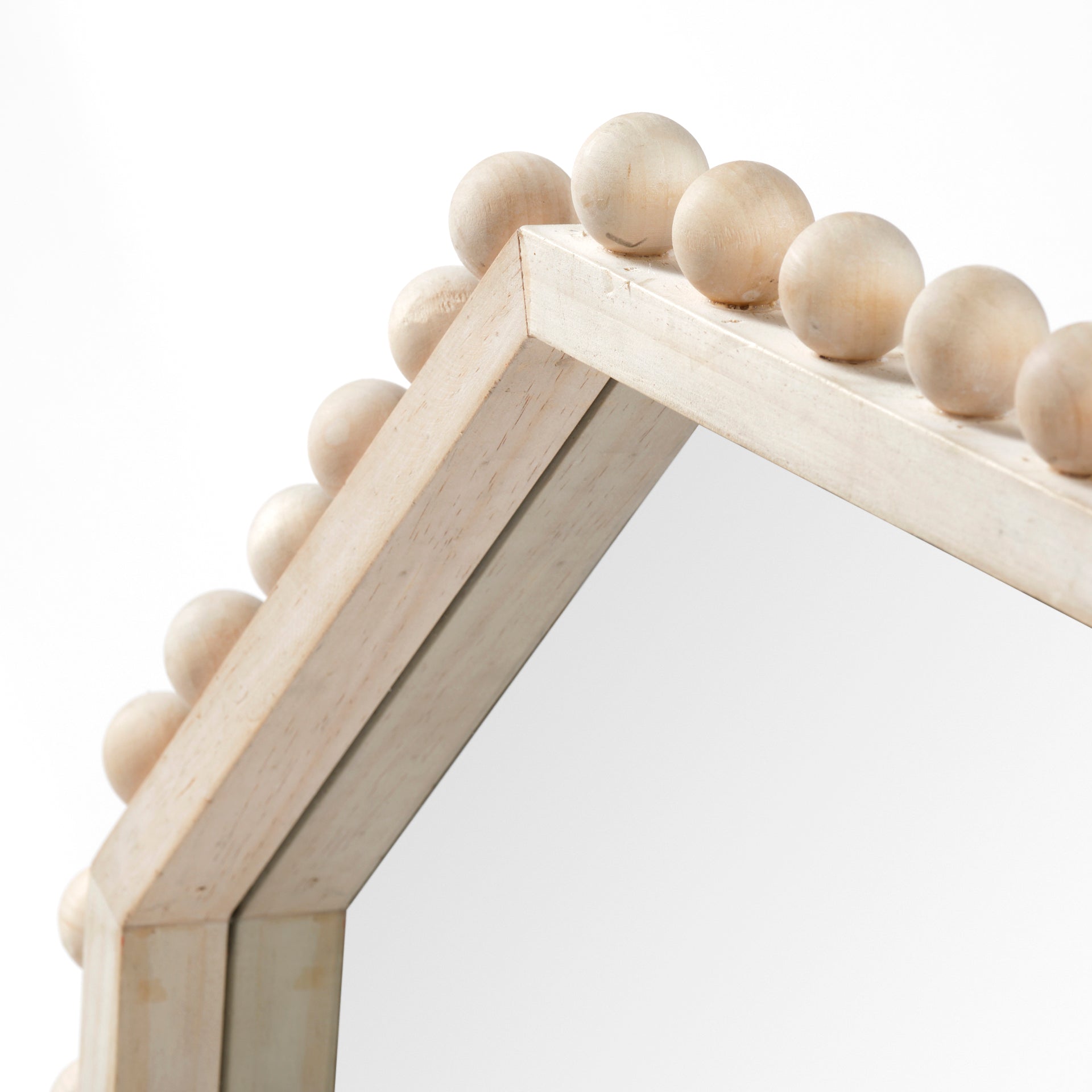 A WOOD FRAMED MIRROR WITH AN octogonal SHAPE AND BEADED DETAIL AROUND THE EDGE.