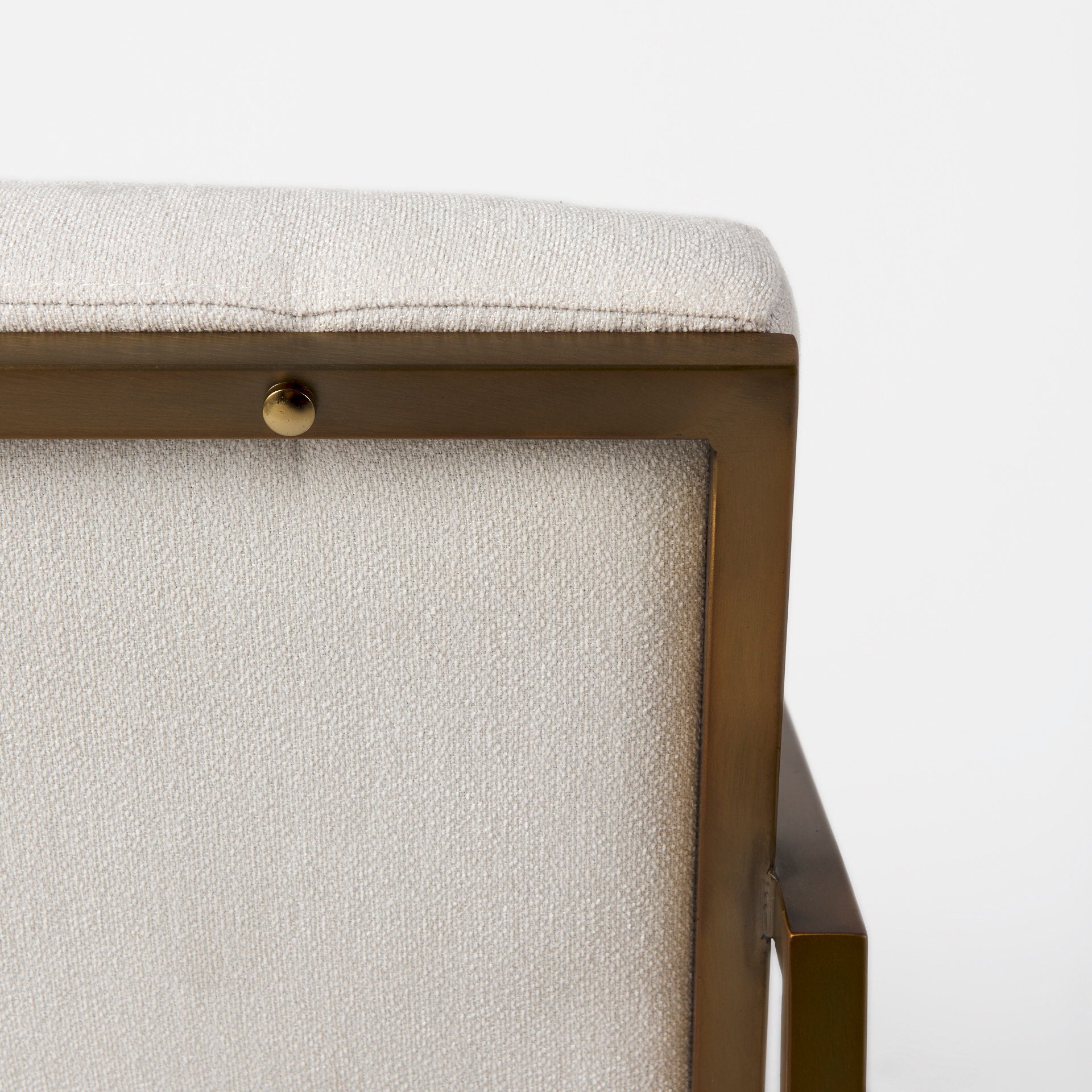 A metal and fabric accent chair oozing angular elegance.  Gold metal frame and cream fabric.