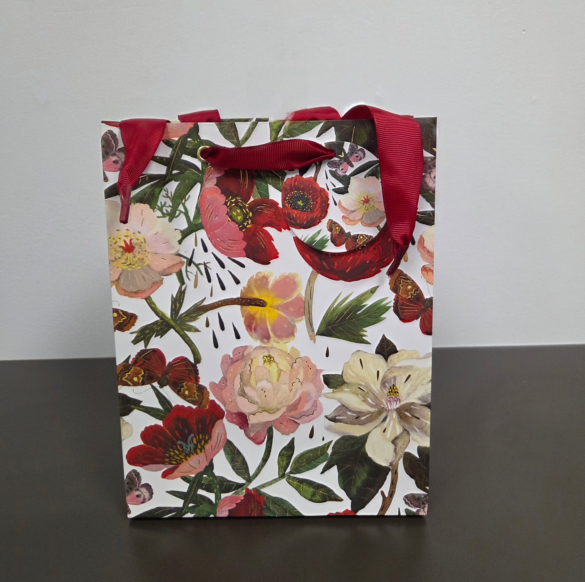Floral gift bag with a red ribbon 