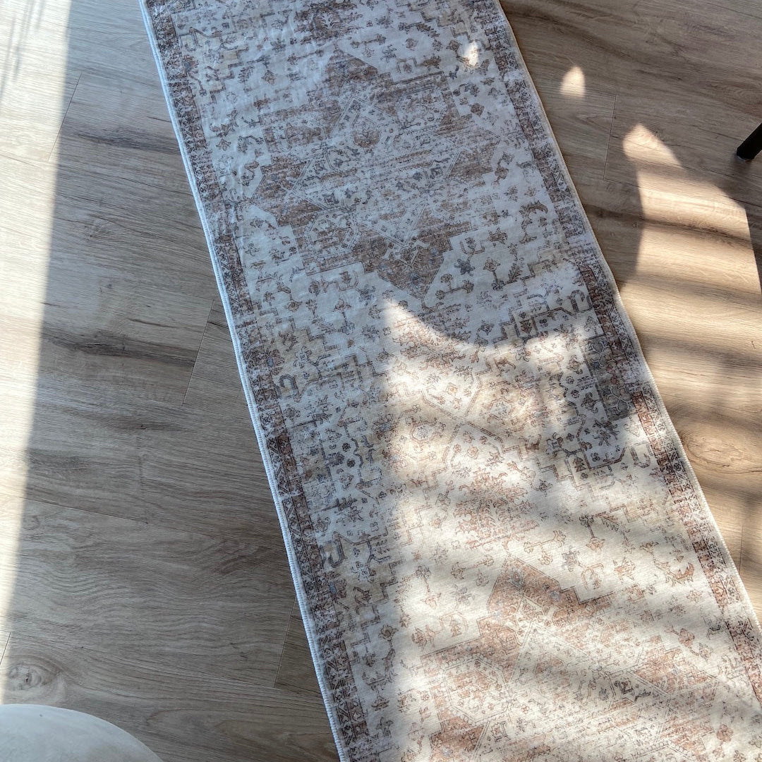 Rectangular area rug with a pattern on a wooden floor