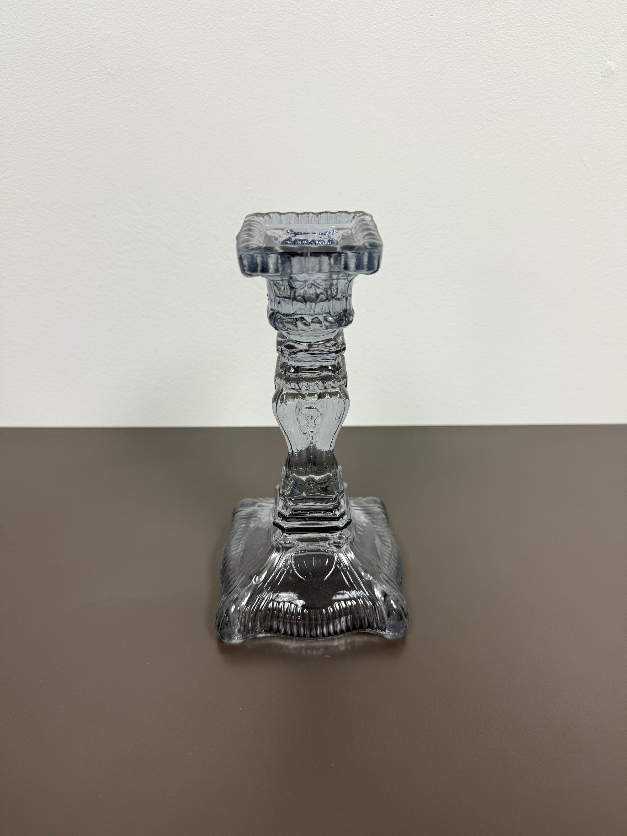 Decorative glass candle holder on a two-tone background