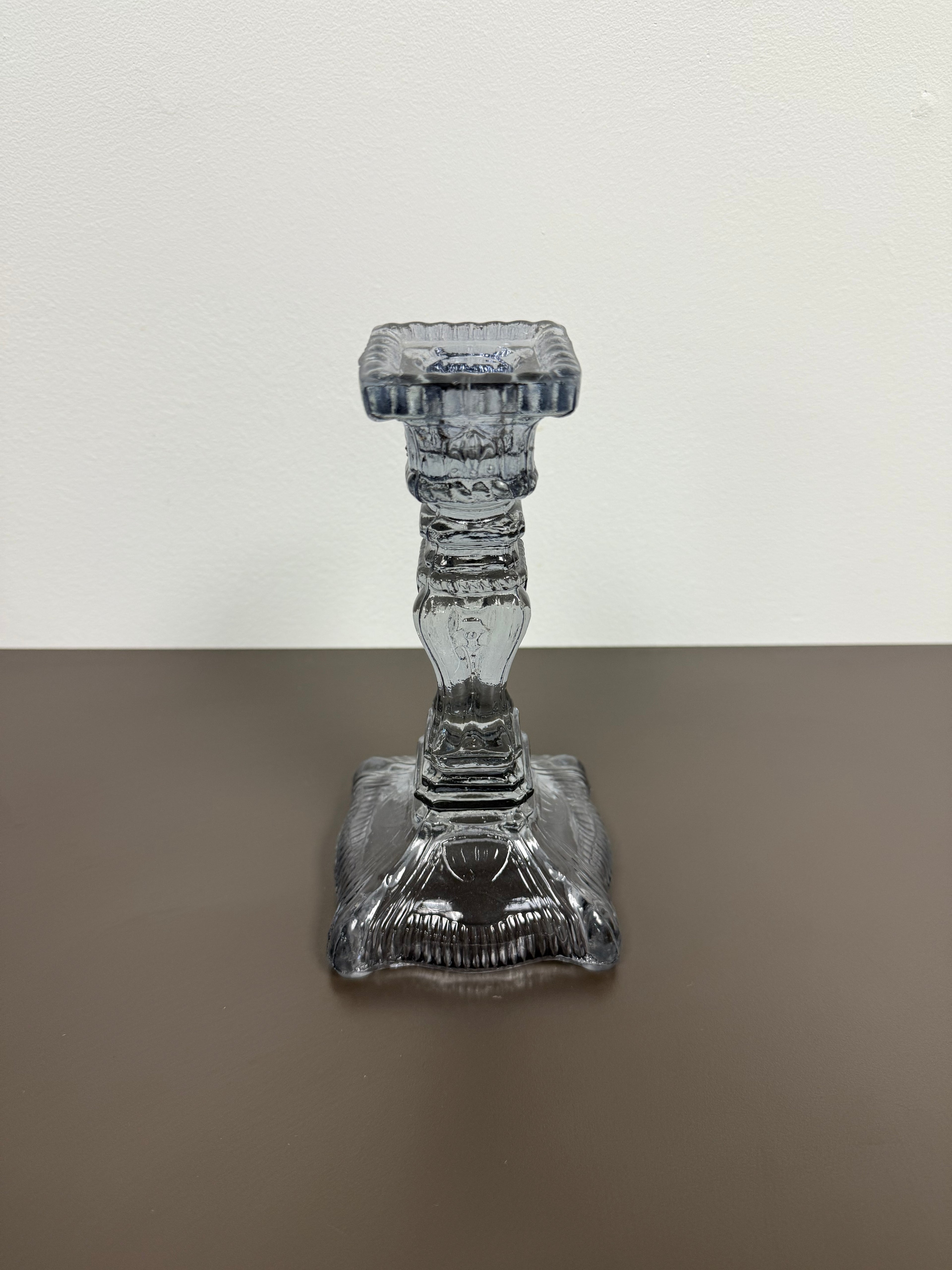Decorative glass candle holder on a two-tone background
